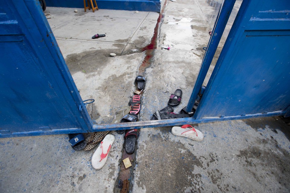 Inmates' sandals lay at the main gate of the Civil Prison in the coastal town of Arcahaiea