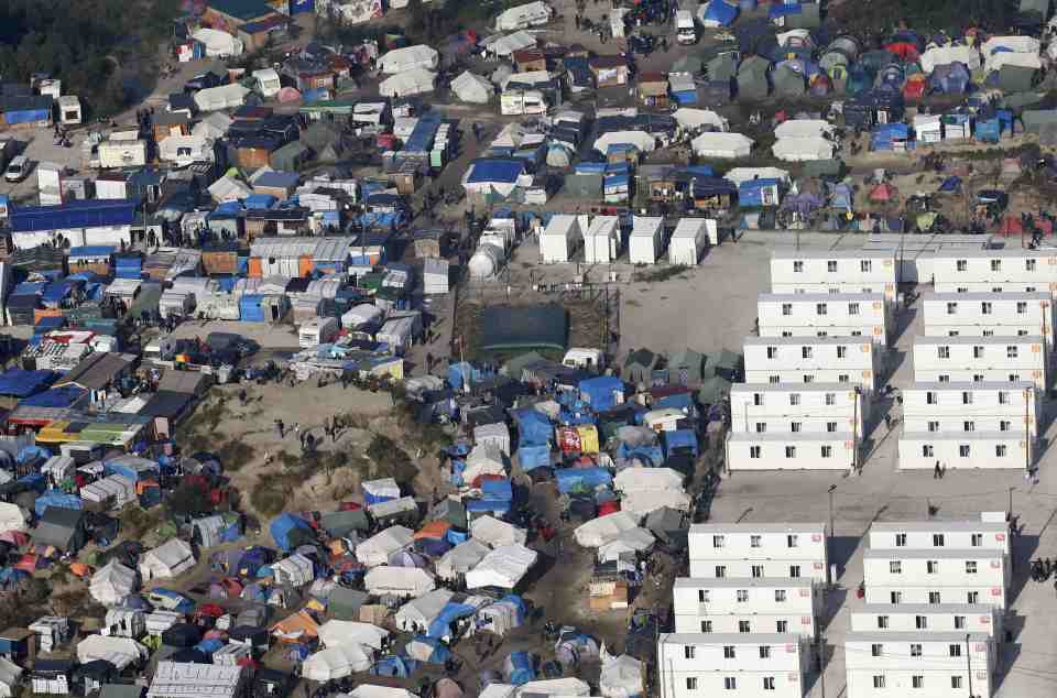 An aerial view shows white containters, tents and makeshift shelters on the eve of the evacuation and dismantlement of the camp called the "Jungle" in Calais