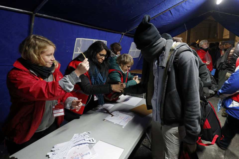 A migrant queues to receive a bracelet before being transferred to a reception centres