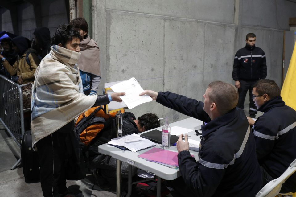 Migrants wait at a processing centre to be registered on the second day of their evacuation and transfer to reception centers in France, during the dismantlement of the camp called the "Jungle" in Calais