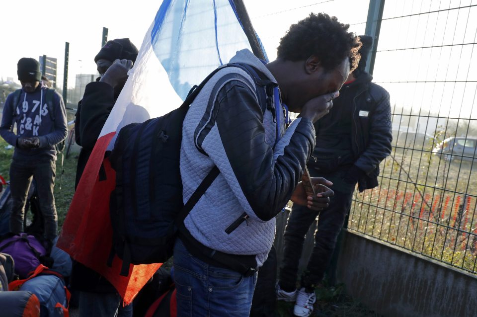 One migrant, pictured, was seen crying for his family as he prepared to leave the Jungle after eight months