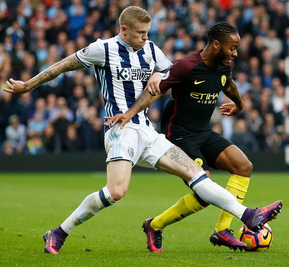 Man Citys Raheem Sterling views with WBAs James McClean