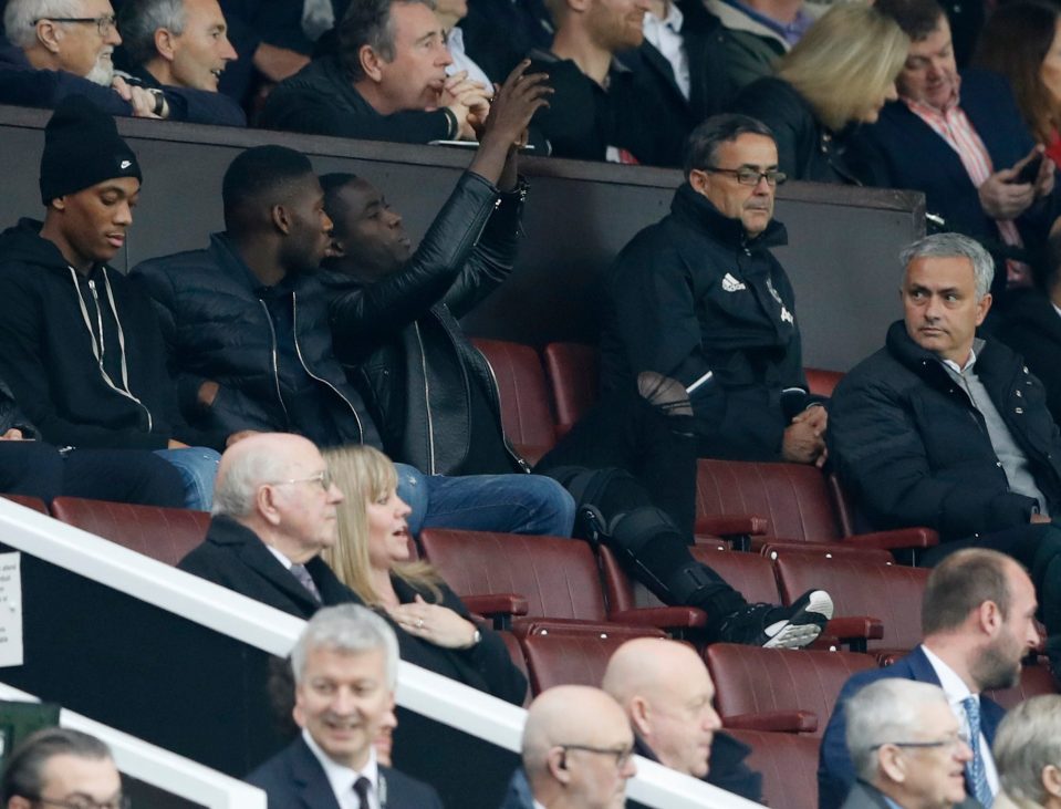 Eric Bailly looks to be taking a picture of his boss Jose Mourinho