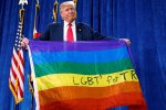 Donald Trump looked slightly sheepish as he held up an LGBT flag given to him by an audience member