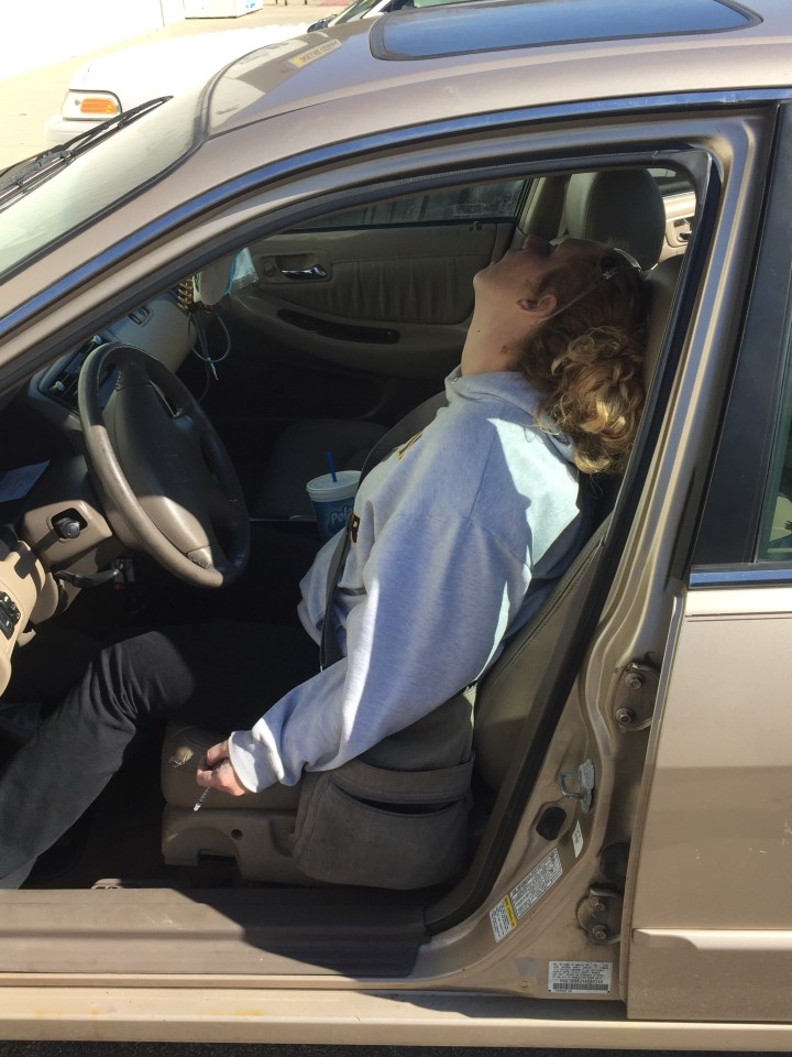 In this Saturday, Oct. 22, 2016 photo provided by the Town of Hope Police Department, Erika Hurt sits with her baby in the back seat of the car in Hope, Ind. Police said she appeared unresponsive from an overdose and had a syringe in her hand. (Town of Hope Police Department via AP)