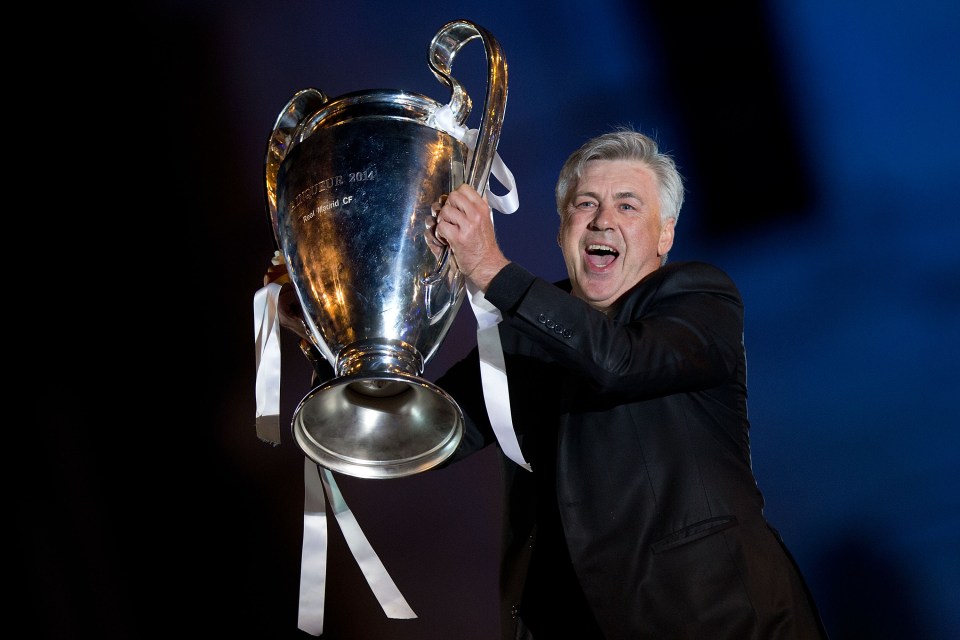MADRID, SPAIN - MAY 25: Head coach Carlo Ancelotti of Real Madrid CF holds the UEFA Champions League cup celebrating their victory on the UEFA Champions League Final match against Club Atletico de Madrid at Cibeles square on the early morning of May, 25, 2014 in Madrid, Spain. Real Madrid CF achieves their 10th European Cup at Lisbon 12 years later. (Photo by Gonzalo Arroyo Moreno/Getty Images)