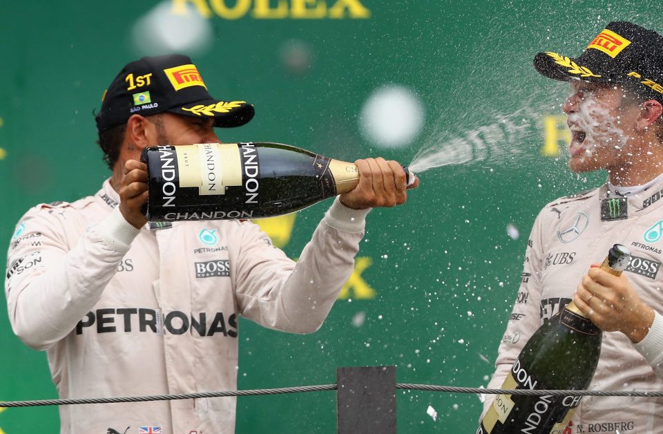 Race winner Lewis Hamilton and his second-placed Mercedes team-mate Nico Rosberg celebrate after the Brazil GP