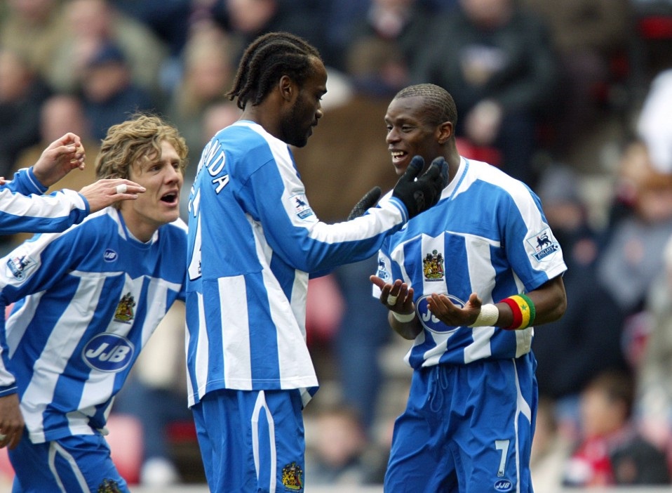 Jimmy Bullard and Pascal Chimbonda share the joy at Wigan as they celebrate a Henri Camara goal