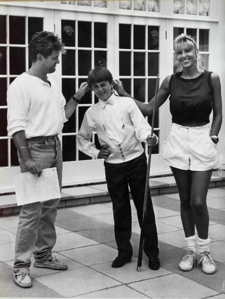  Head of the cue . . . Junior player Ronnie with his parents