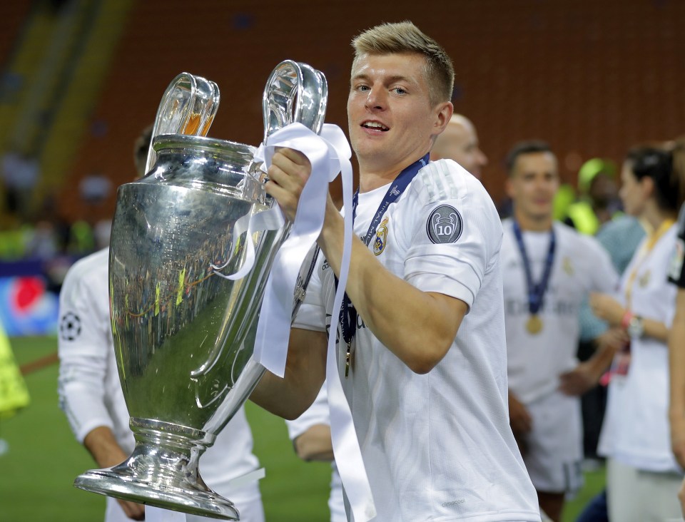 FILE - In this May 28, 2016 file photo, Real Madrid's Toni Kroos celebrates with the trophy after the Champions League final soccer match between Real Madrid and Atletico Madrid at the San Siro stadium in Milan, Italy. Real Madrid said on Thursday Oct. 13, 2016 that it has extended the contract of Germany midfielder Toni Kroos until June 2022. (AP Photo/Manu Fernandez, File)