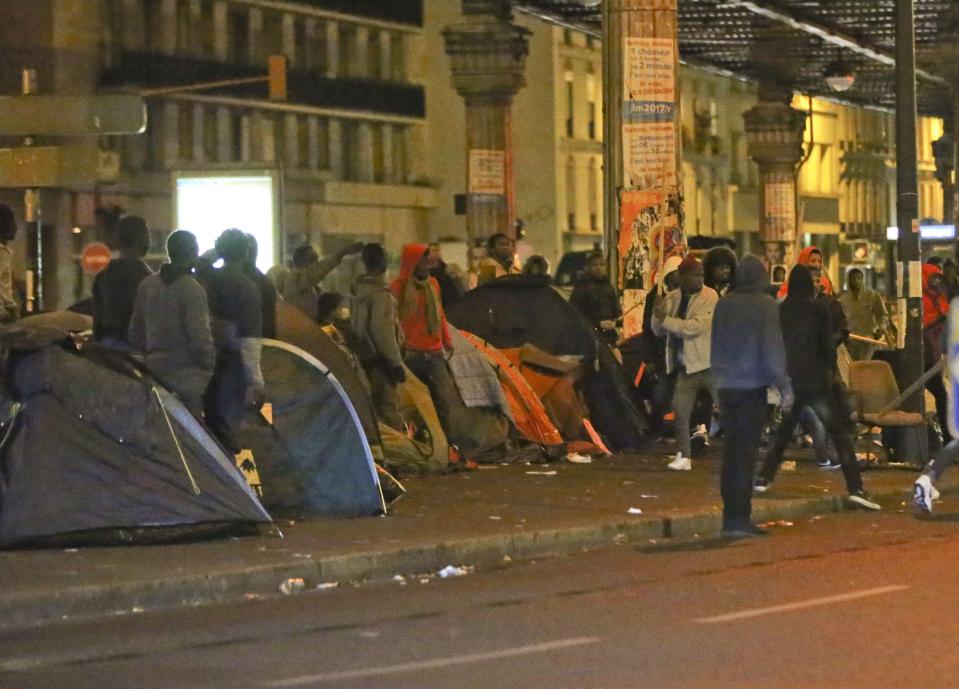 Riot police rushed to the scene after violence broke out between competing gangs between the tents that now house hundreds of migrants