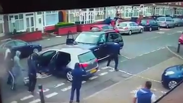 One man is seen to attack a Range Rover with a large white pole