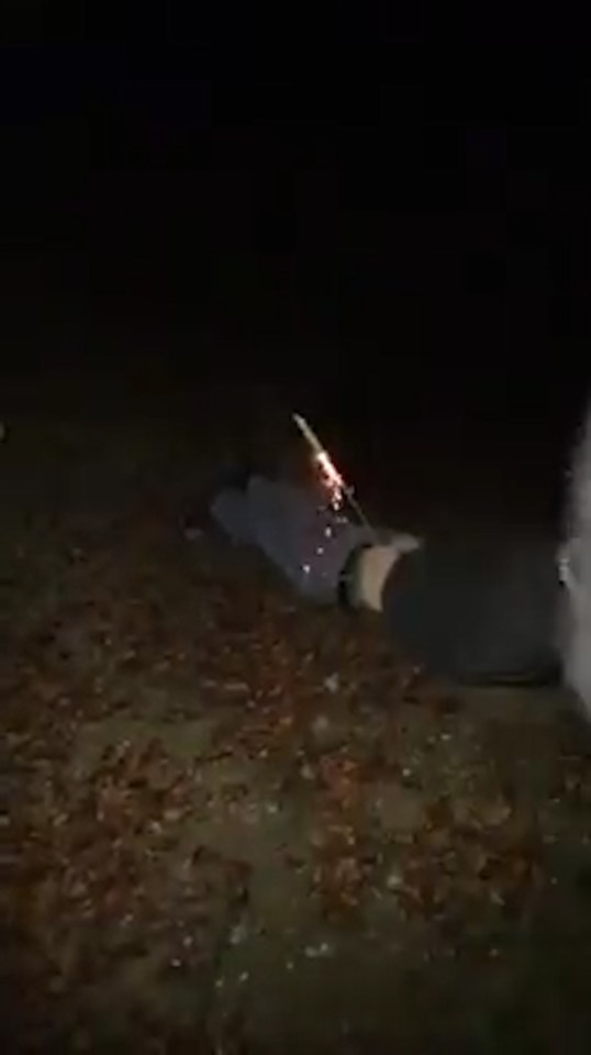 Music and laughter can be heard in the background as the firework is lit