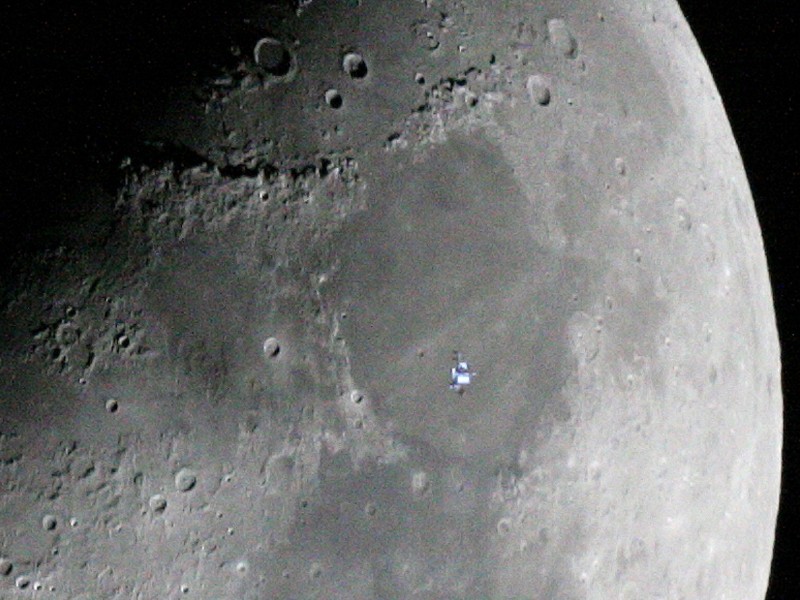 The International Space Station passes in front of the moon