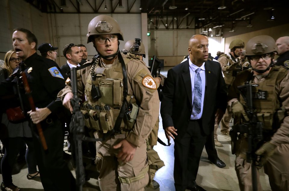 Armed and dangerous . . . heavily armed cop at event after Trump is whisked away