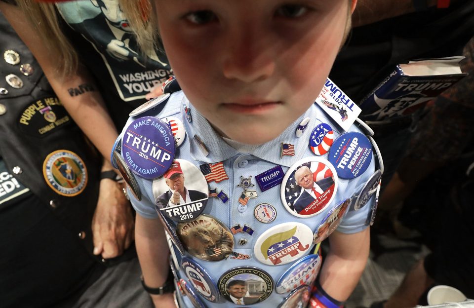 Mason Haliburton, 8, of Omaha, Nebraska, wears campaign buttons that he has collected from five different Trump rallies