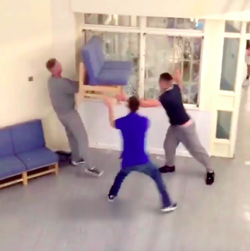 Prisoners were seen using a sofa to smash a window