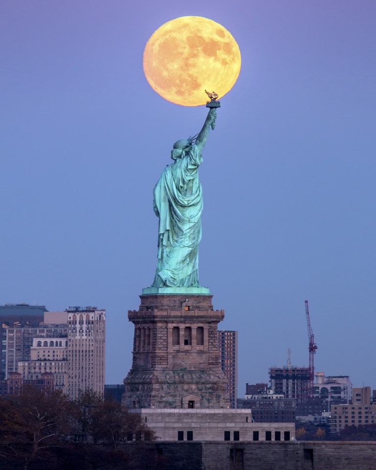 The supermoon appears like the glow of the Statue of Liberty's torch in New Yorkk