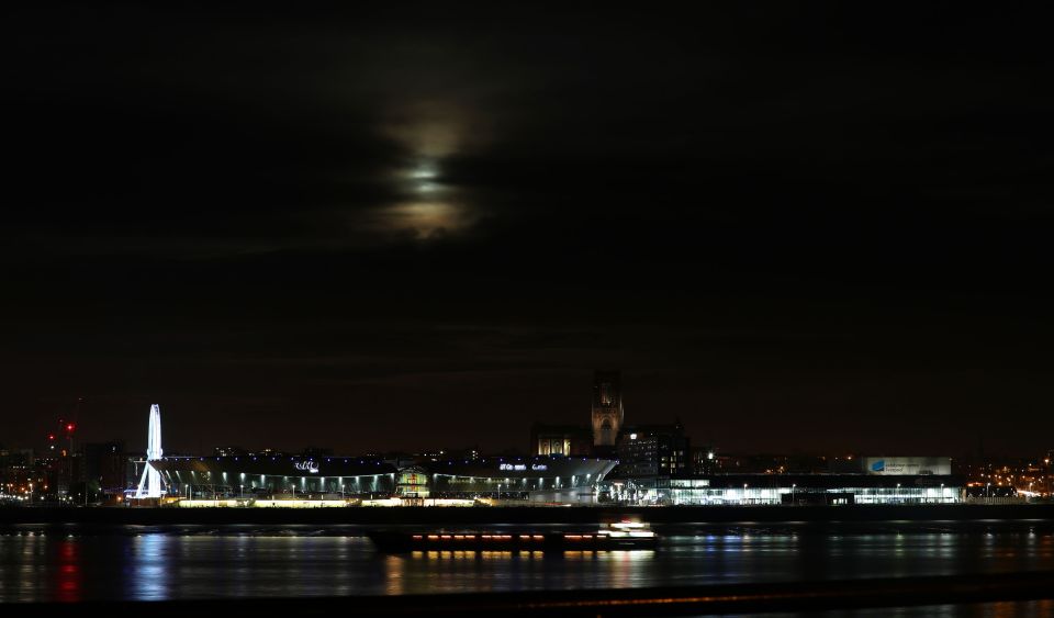 supermoon is seen through the clouds above Liverpool Anglican Cathedral