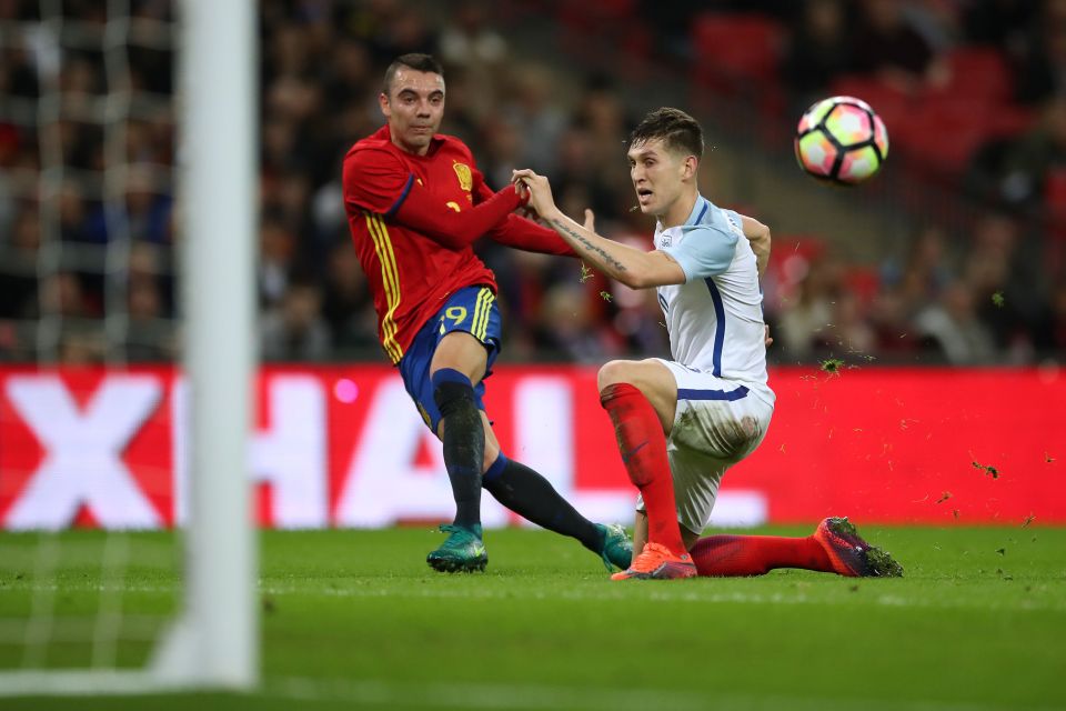 Iago Aspos curls his shot around John Stones to bring Spain back into the game