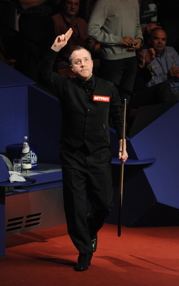 John Higgins salutes the crowd after making a maximum in Belfast