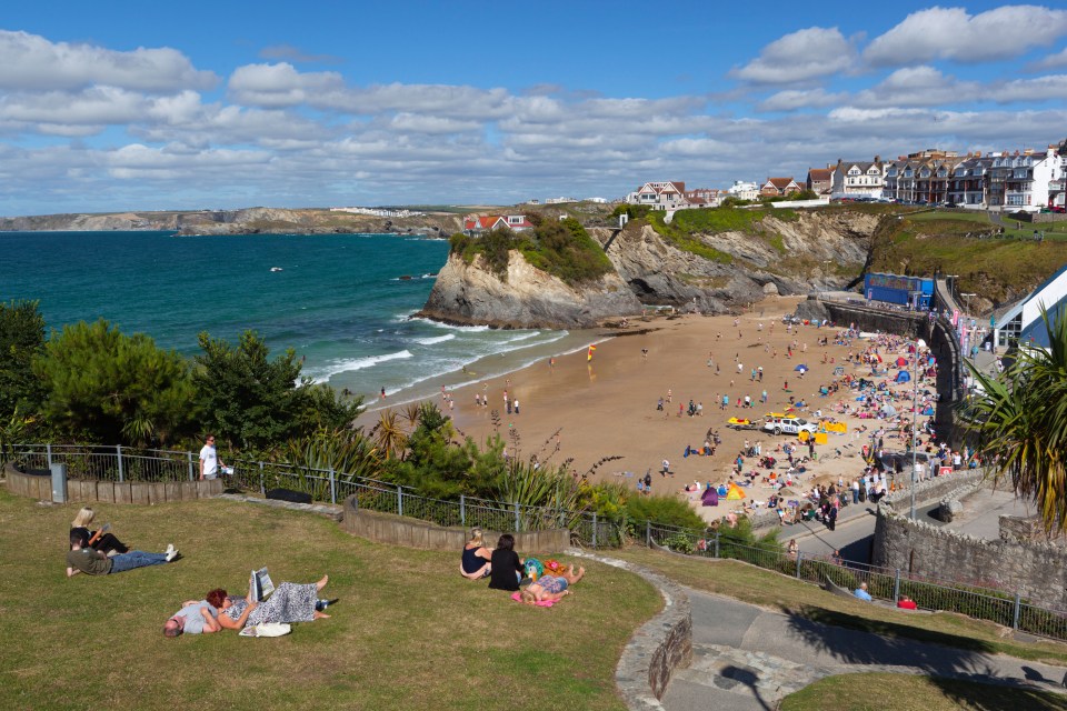 People relaxing in park above Towan beach, Newquay, Cornwall