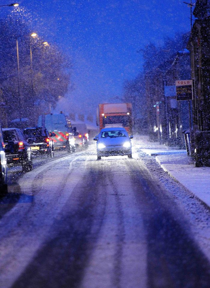 Motorists carefully drive along the M62 Snow in Lees and Springhead, Oldham