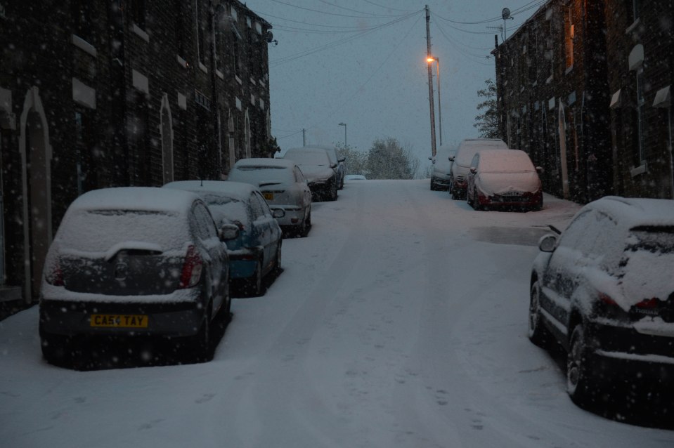 Cars were left covered in snow when people awoke for their morning commute in Mossley, Lancashire 