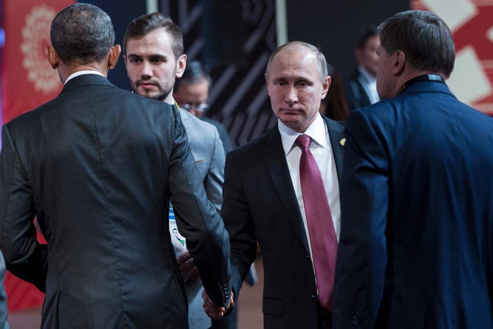 The world leaders barely looked at each other as they clasped hands