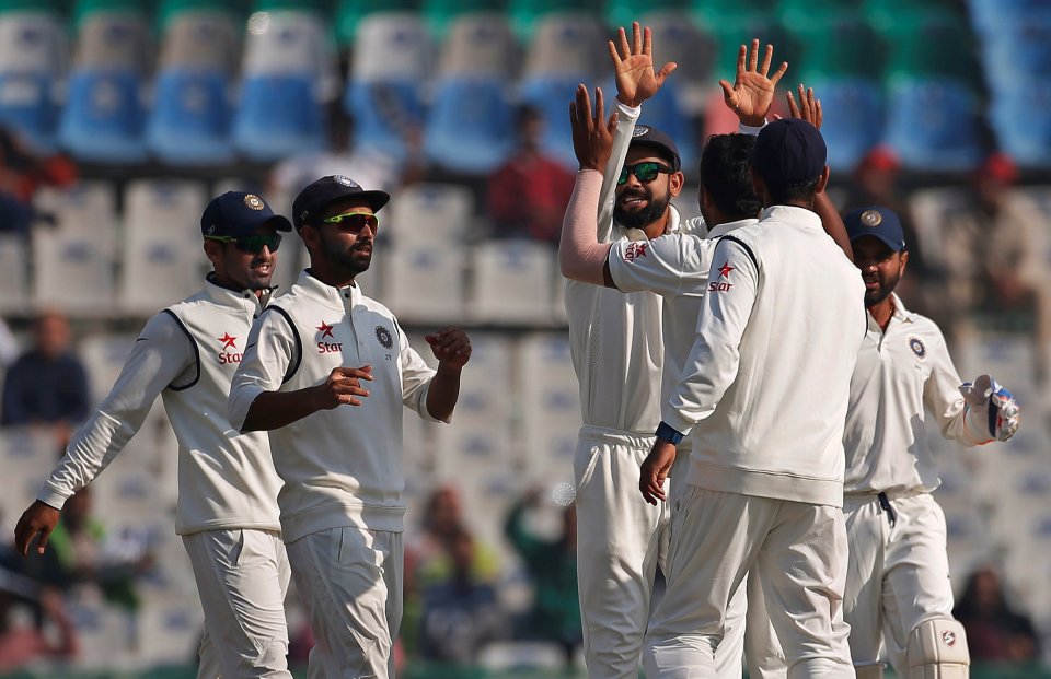 India's fielders celebrate taking another wicket in Mohali
