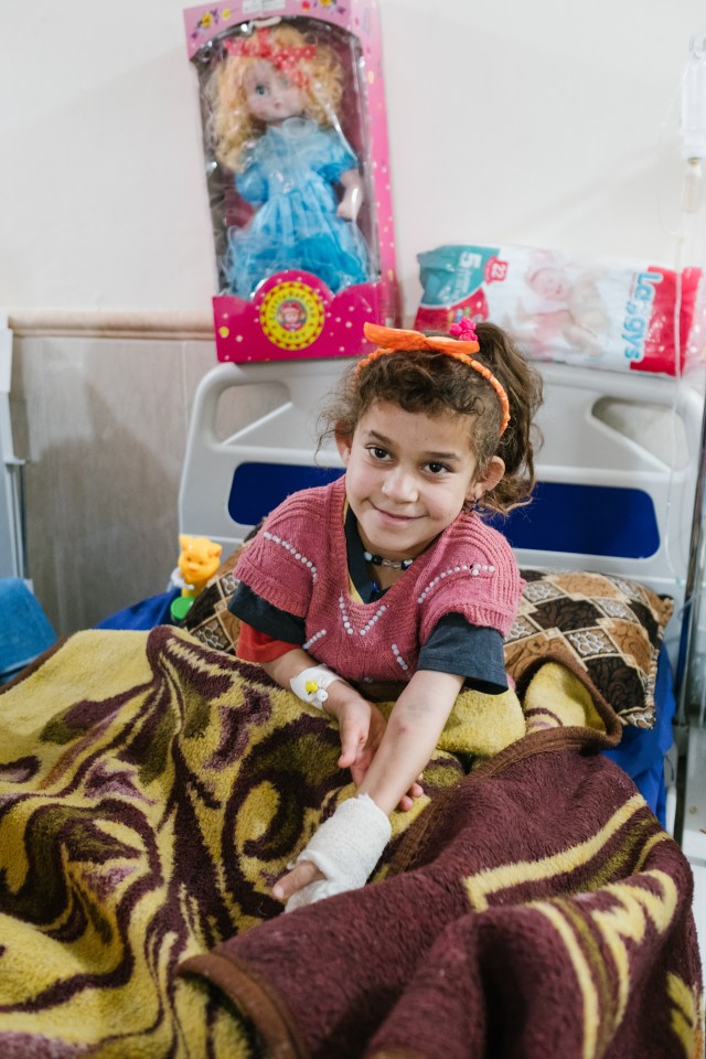 Glimmer of hope ... the smile on a young girl's face reveal how important toys can be in the rehabilitation process