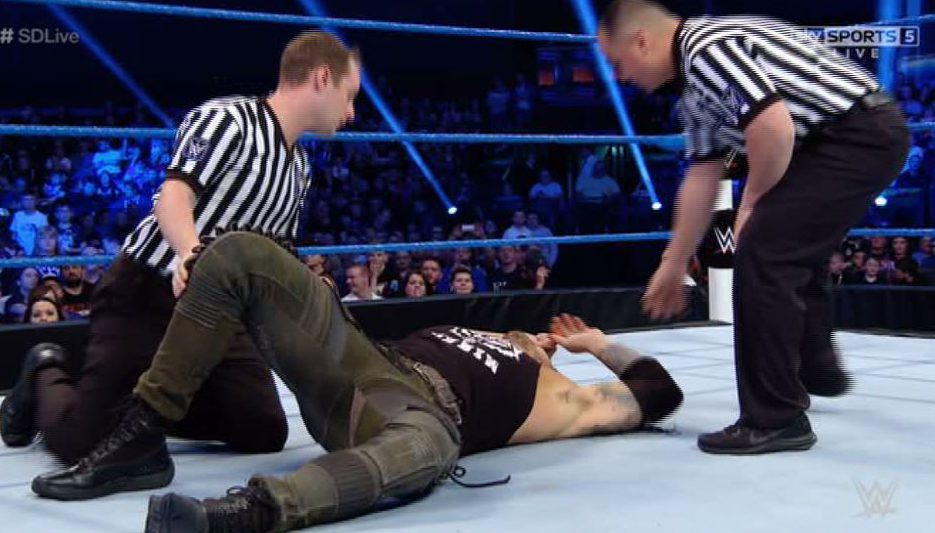 Baron Corbin lays on the canvas after Kalisto attacked his injured knee