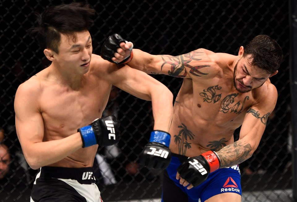 TORONTO, CANADA - DECEMBER 10: (R-L) Cub Swanson punches Dooho Choi of South Korea in their featherweight bout during the UFC 206 event inside the Air Canada Centre on December 10, 2016 in Toronto, Ontario, Canada. (Photo by Jeff Bottari/Zuffa LLC/Zuffa LLC via Getty Images)