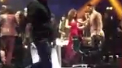 The pair can be seen touching each other's arms by the judge's table