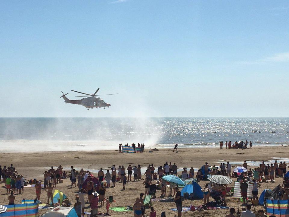 An emergency helicopter arrives at Camber Sands - the day five friends drowned at the beach