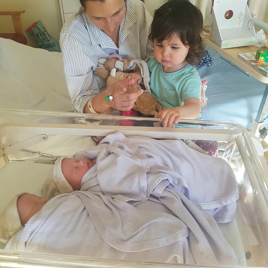 Rachel and Nora look lovingly at the new family additions shortly after the birth - unbeknown that they had contracted the illness