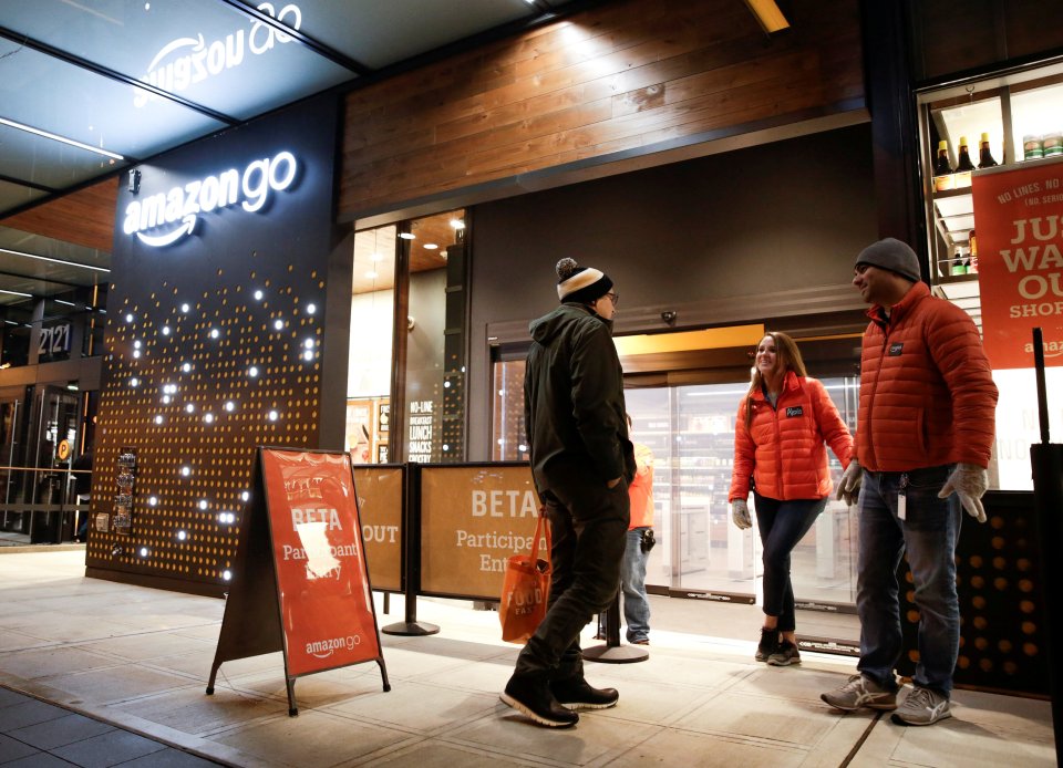 Amazon employees outside the Amazon Go brick-and-mortar shop, which allows customers to pick up without queuing at a checkout