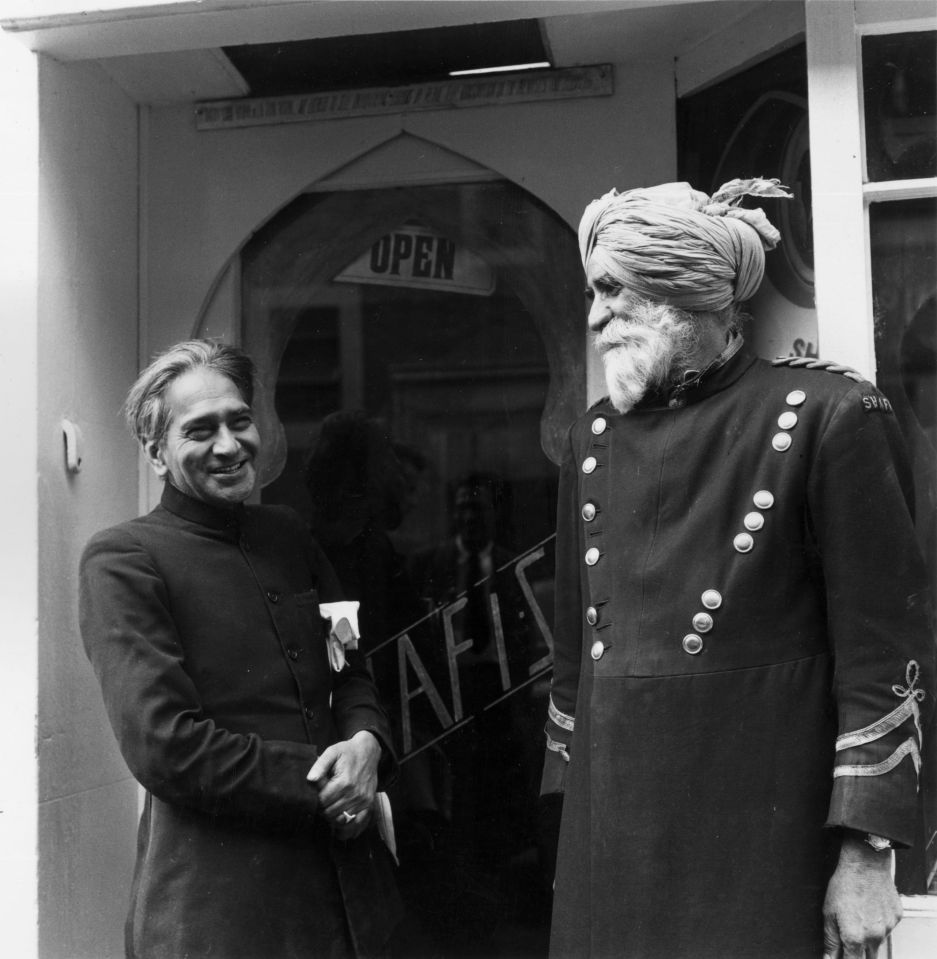 1956: The doorman and proprietor outside and Indian Restaurant in an Indian Community in London