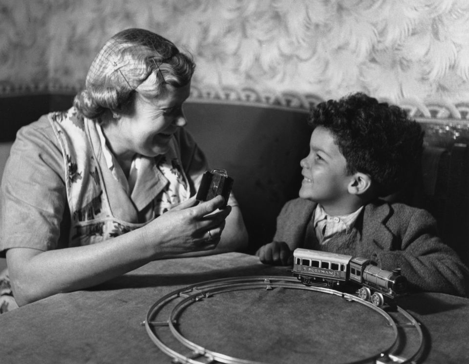22nd April 1950: A young boy playing with a train set at his home in the Cardiff 