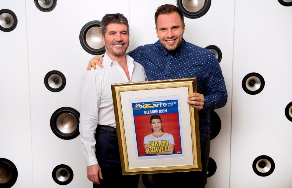 Simon Cowell receives his Bizarre Icon award from Dan Wootton