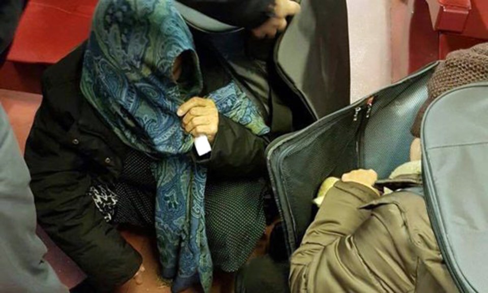 Another migrant pops out of another bag 