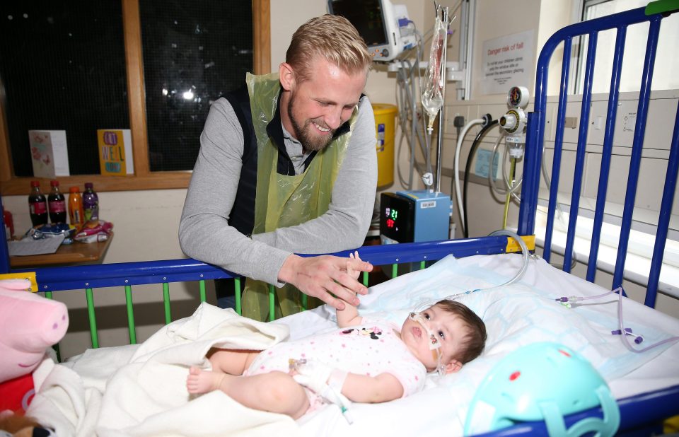  Heartwarming picture as Leicester City goalkeeper Kasper Schmeichel holds the hand of a little baby
