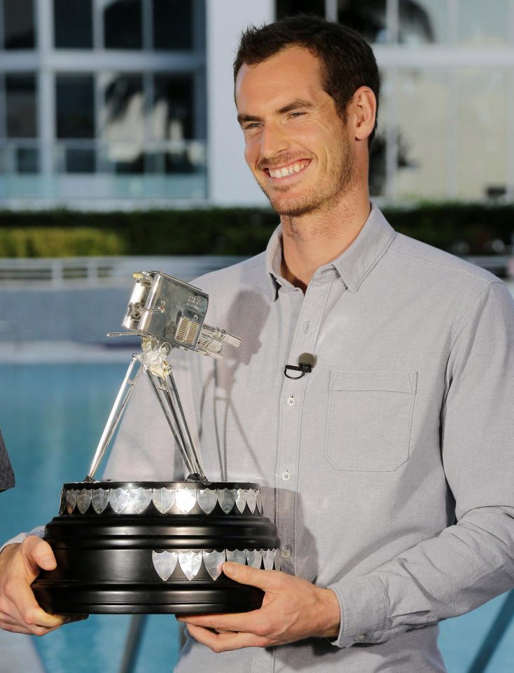  Andy Murray with the patched-up trophy covered in sticky tape