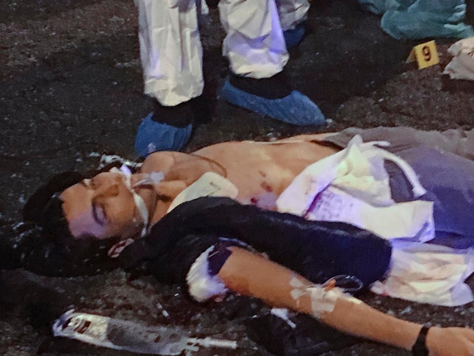 The body of Anis Amri lies on the pavement in the outskirts of Milan