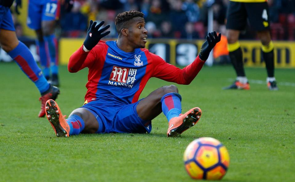 Wilfried Zaha had to be dragged away from a confrontation with Watford mascot Harry the Hornet
