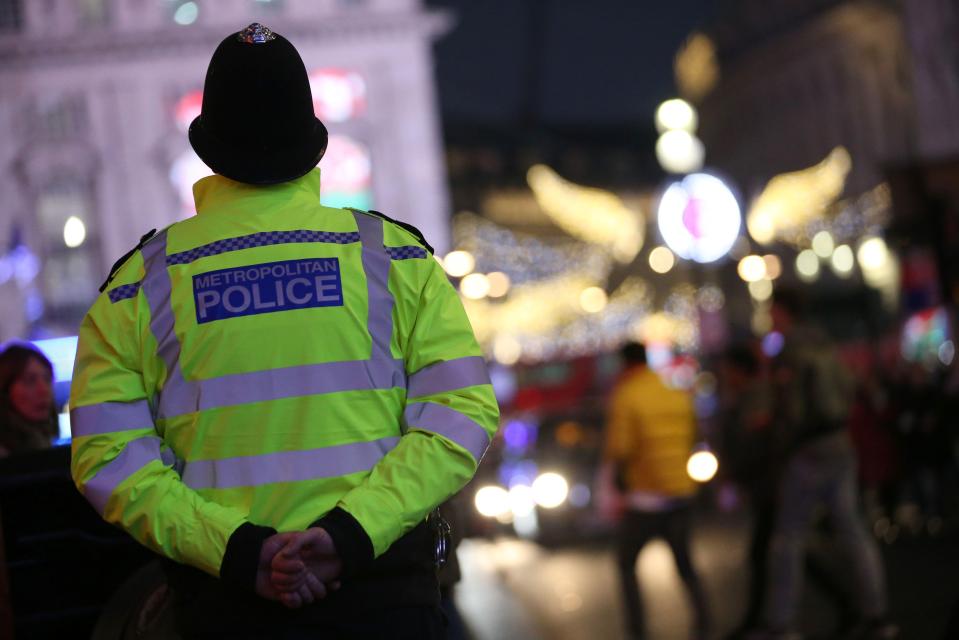  An officer stands guard near Leicester Square in Central London, where thousands will celebrate the New Year