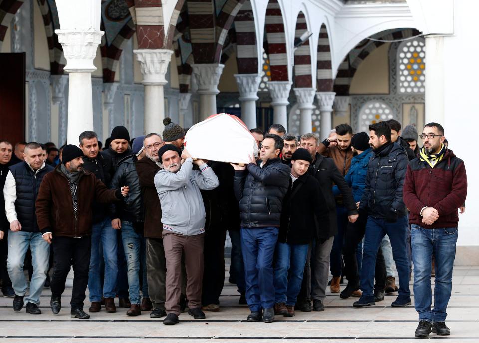 Friends and relatives carry Ayhan Arik's coffin during his funeral today 