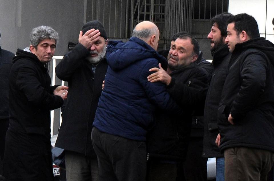 Family members of victims mourn their loved ones outside the morgue