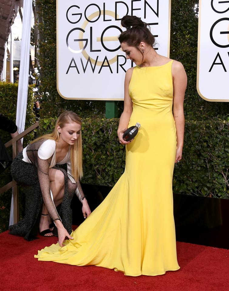  An assistant had to help her straighten the train of her dress