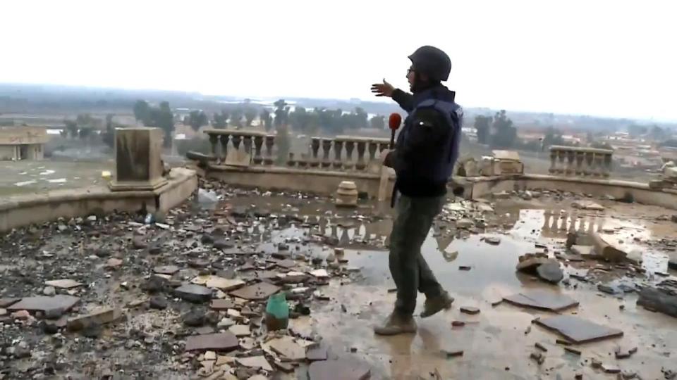 An Iraqi journalist surveys the damaged Mosul Presidential Palace 
